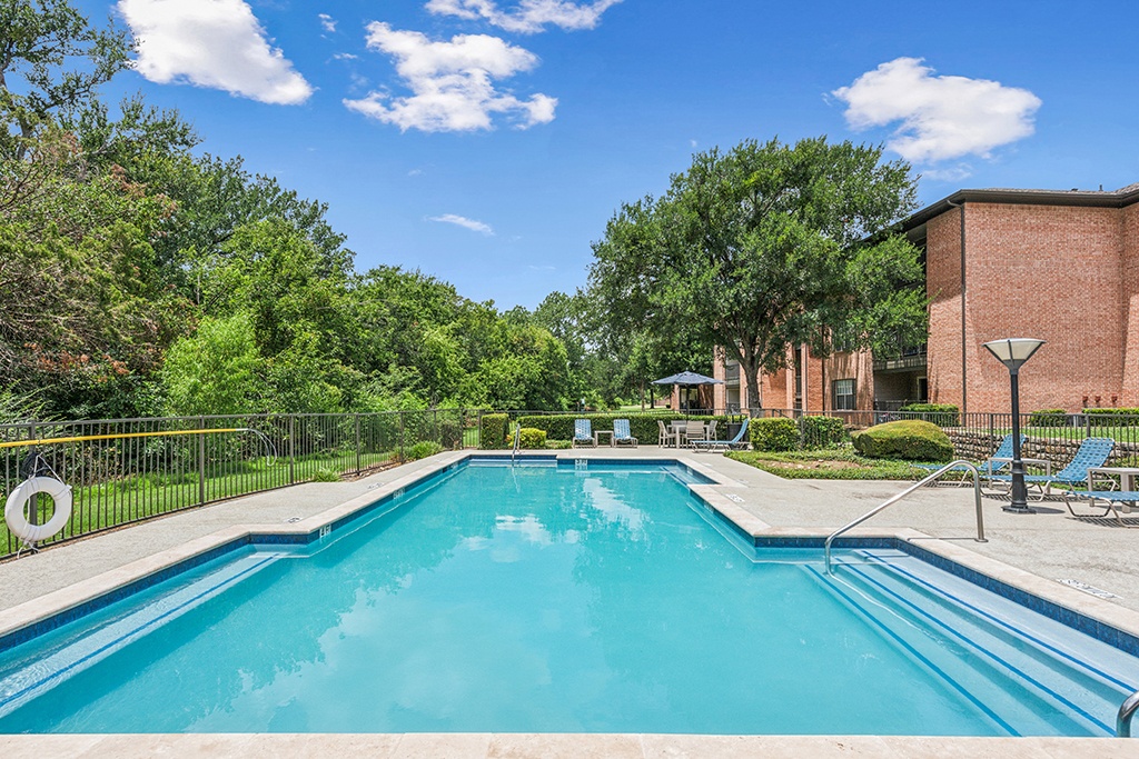 Swimming pool with patio access at Valley Ridge Apartments in Lewisville TX